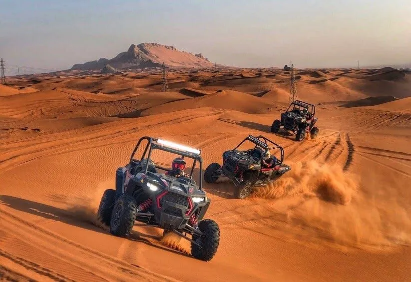 group of people riding dune buggy in the desert and enjoying desert safari abu dhabi with dune buggy ride